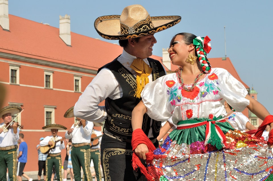 Mexicans dancing wearing traditional costumes