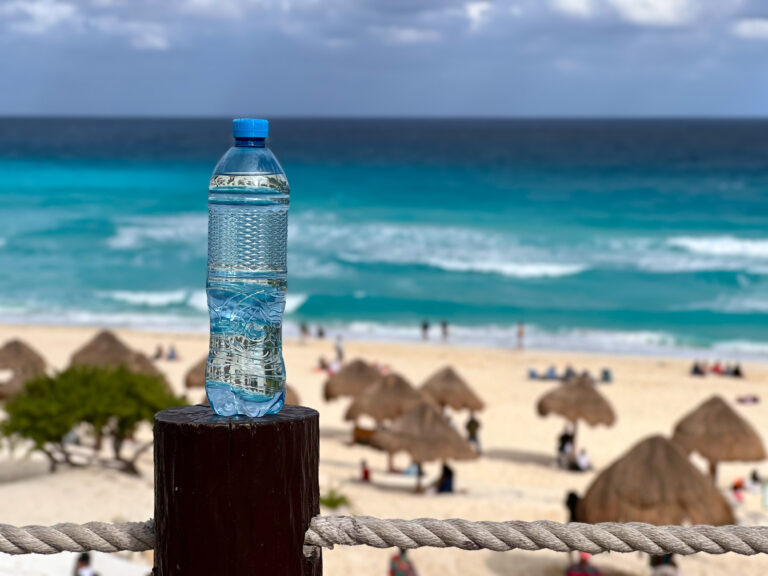 Drinking water in a bottle on a Cancun beach