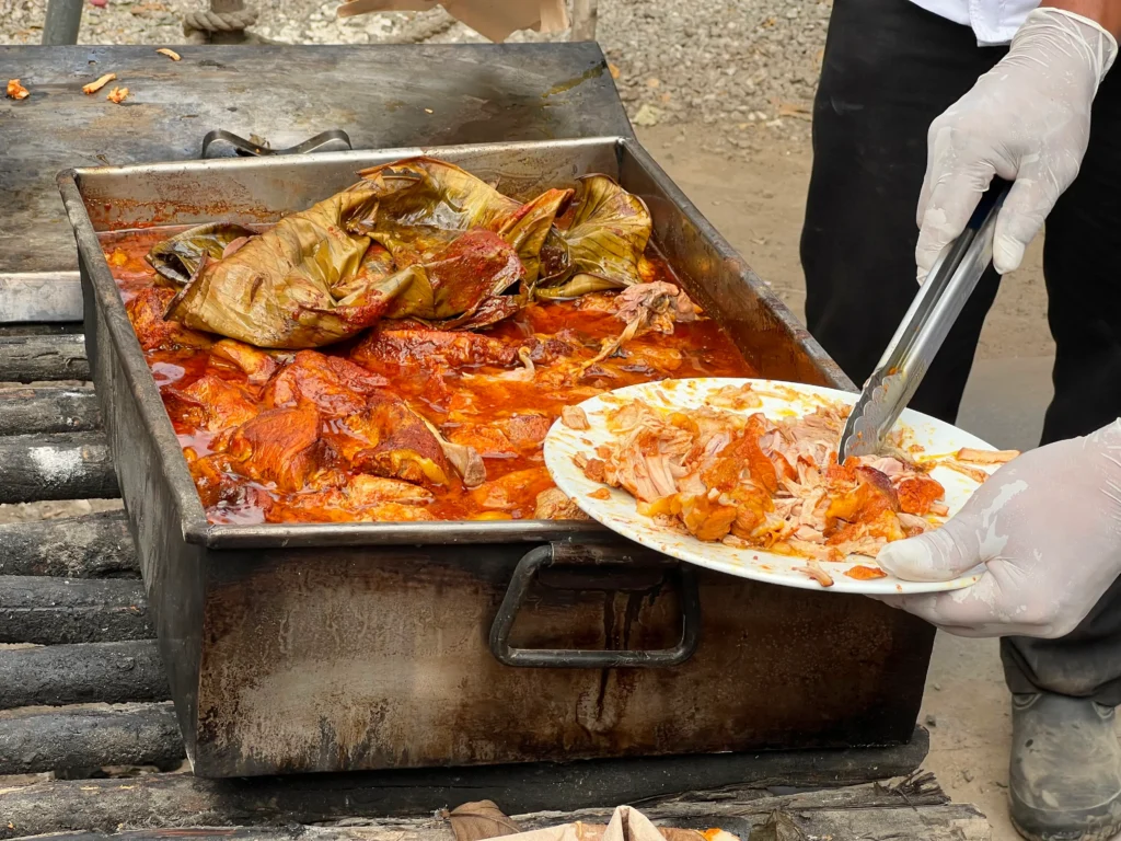 Cochinita pibil being portioned on a plate