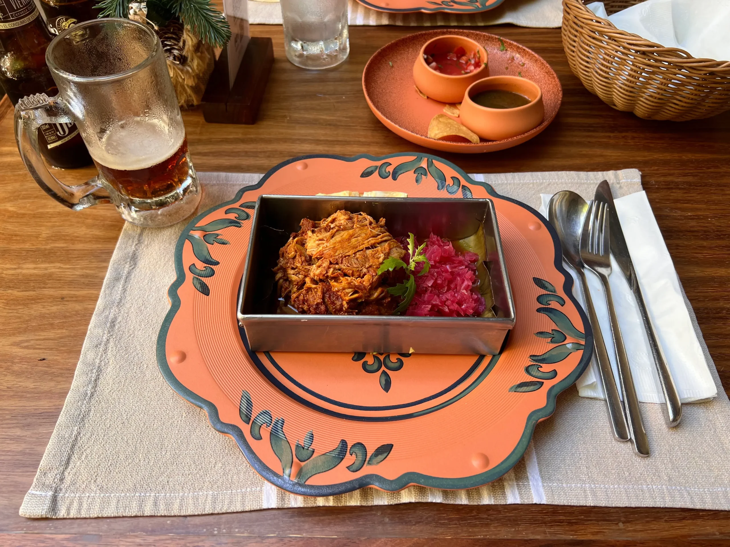 A portion of Cochinita pibil on plat with marinated red onions