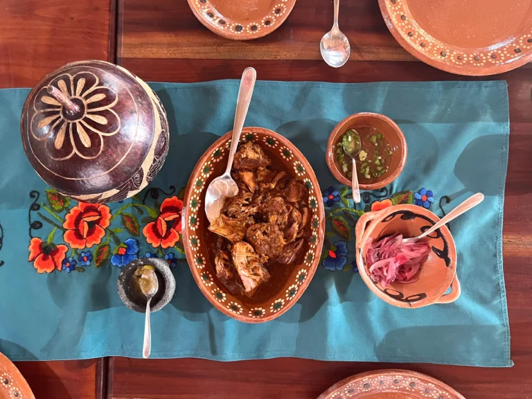 Cochinita pibil served on traditional plates